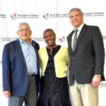 two men and a woman standing for photo