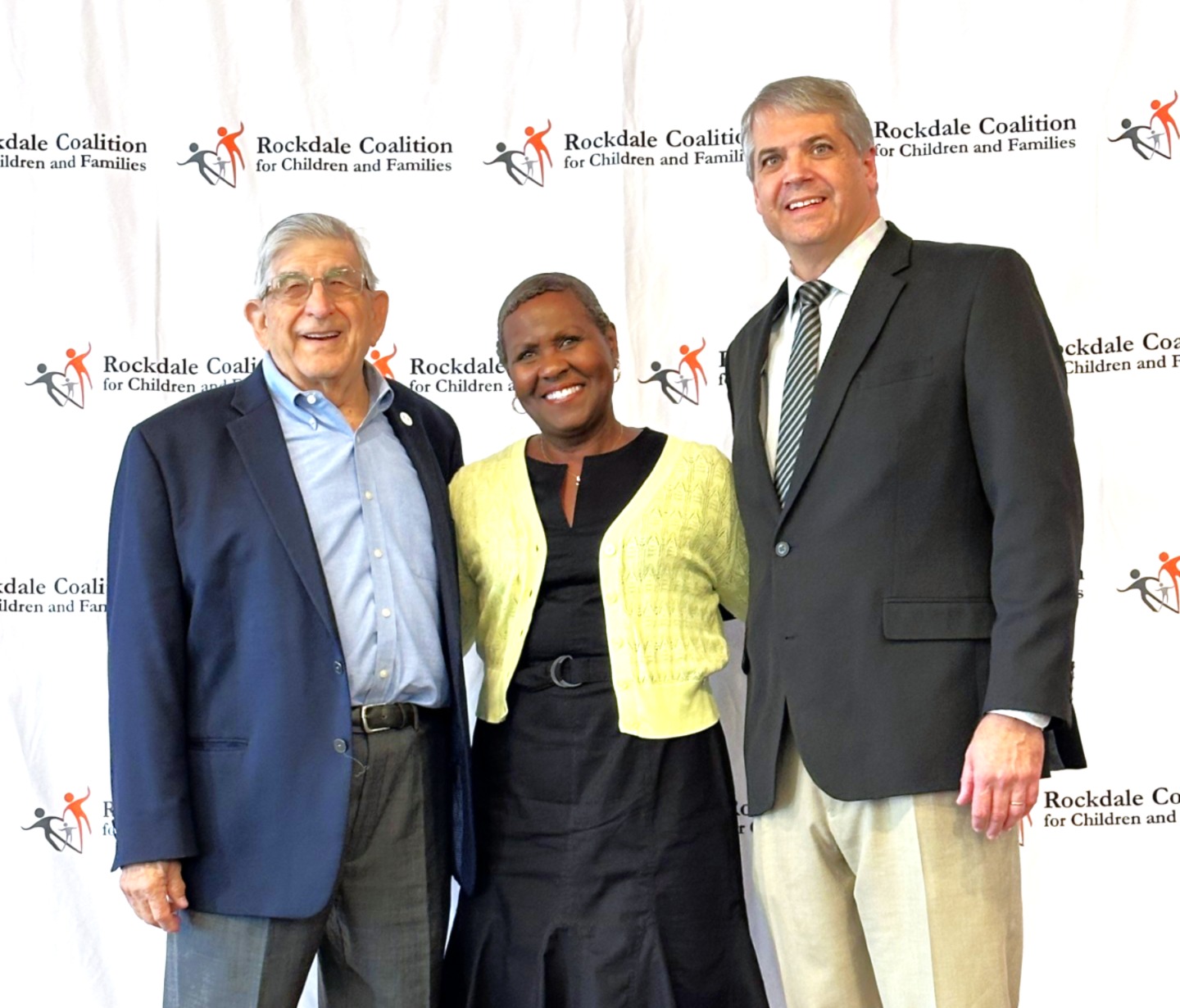 two men and a woman standing for photo